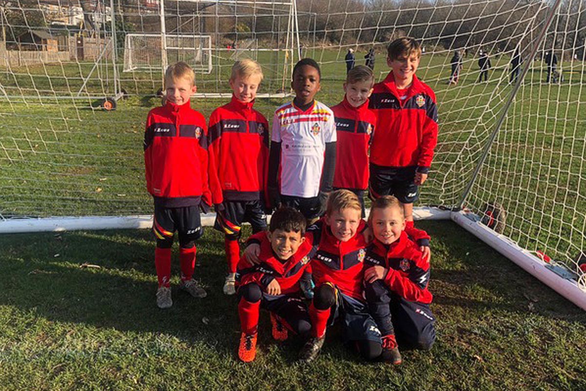 football team wearing red smiling at camera