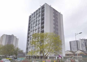 grey building of flats with windows and balconies