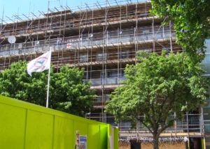 view of building with blue scaffolding