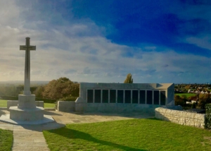 Blue sky and green grass with brick statue