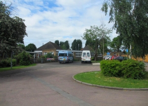 school with buses and a round about